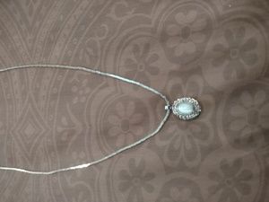 Faux pearl pendant on silver chain.